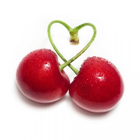 cherries with stems twisted into a heart
