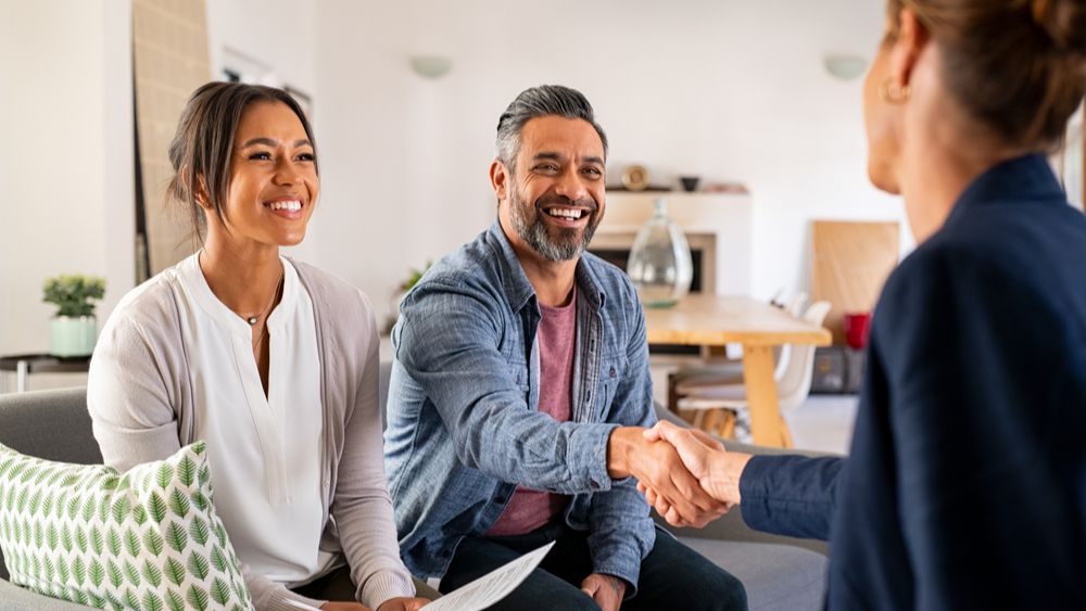 realtor shaking homeowners hand